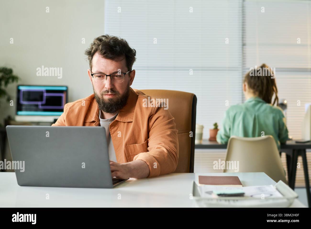 Caucasian Middle Aged Man Coding Neural Network Algorithm in Shared Workspace Stock Photo