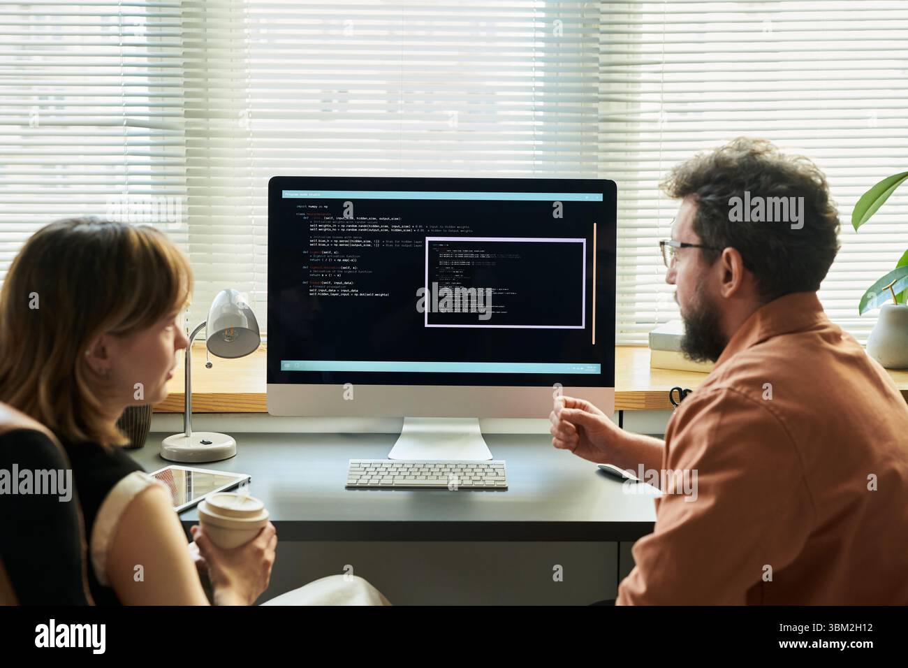 Woman and Man Developing Neural Network Code Stock Photo