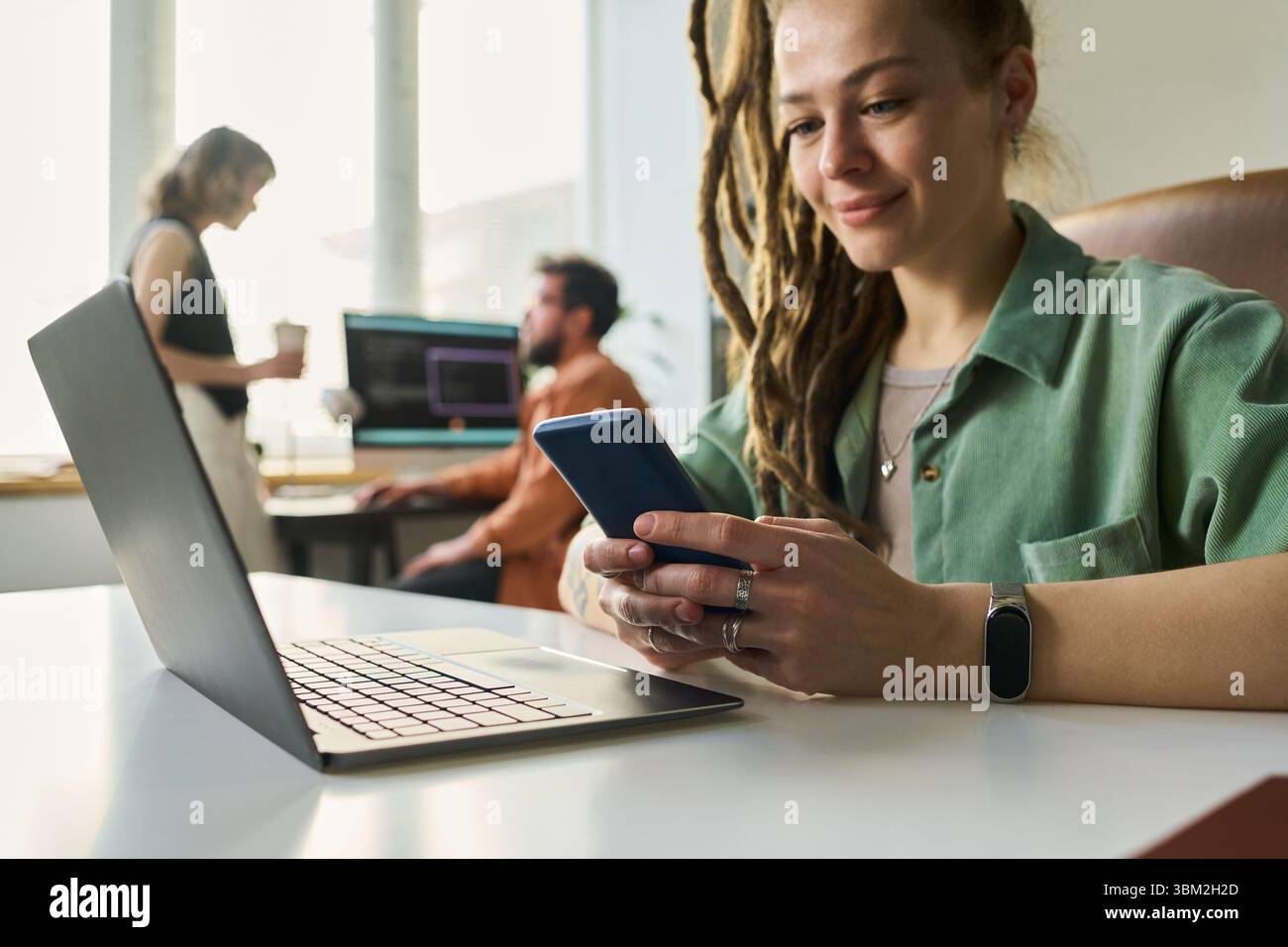 Woman Developing Neural Network Using Laptop and Smartphone Stock Photo