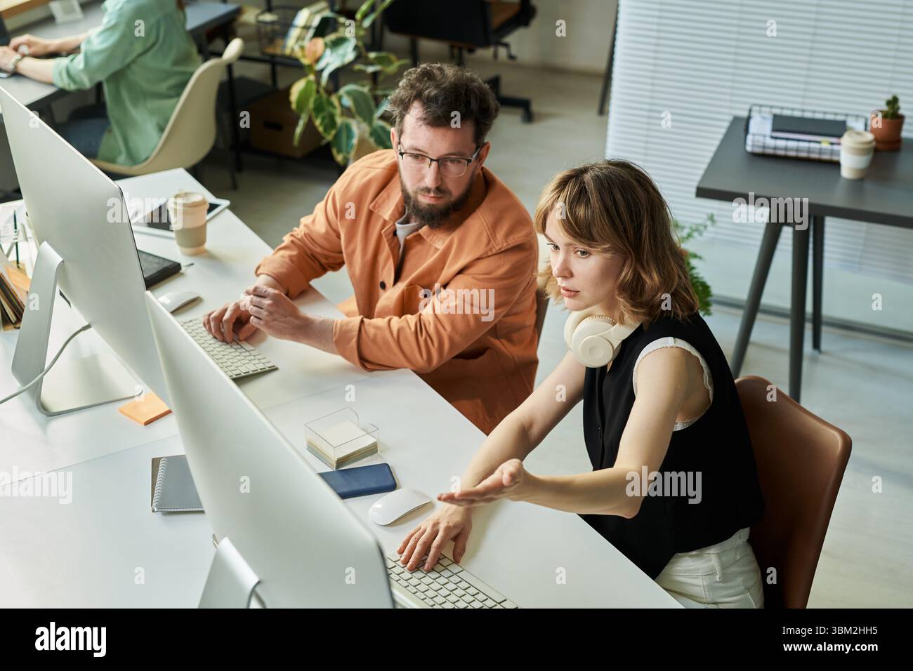 Colleagues Collaborating on Neural Network Development Stock Photo