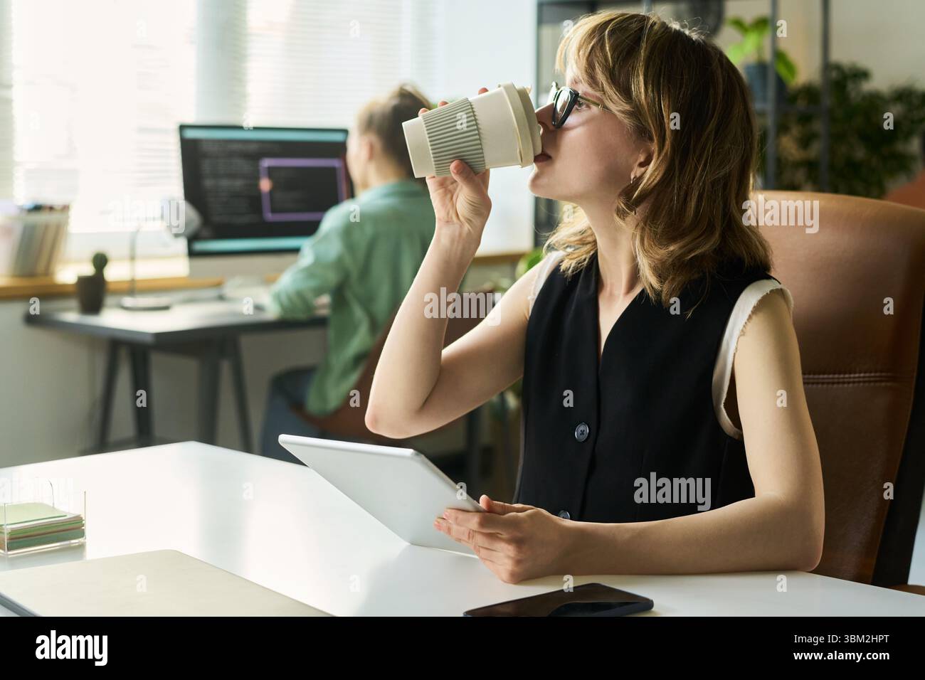 Young Caucasian Woman Developing Neural Network While Drinking Coffee Stock Photo