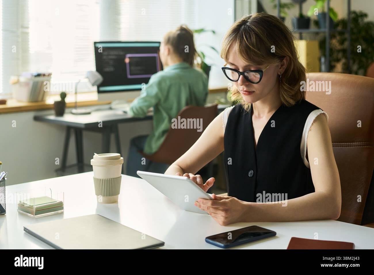 Young Caucasian Woman Using Digital Tablet While Developing Neural Network Stock Photo