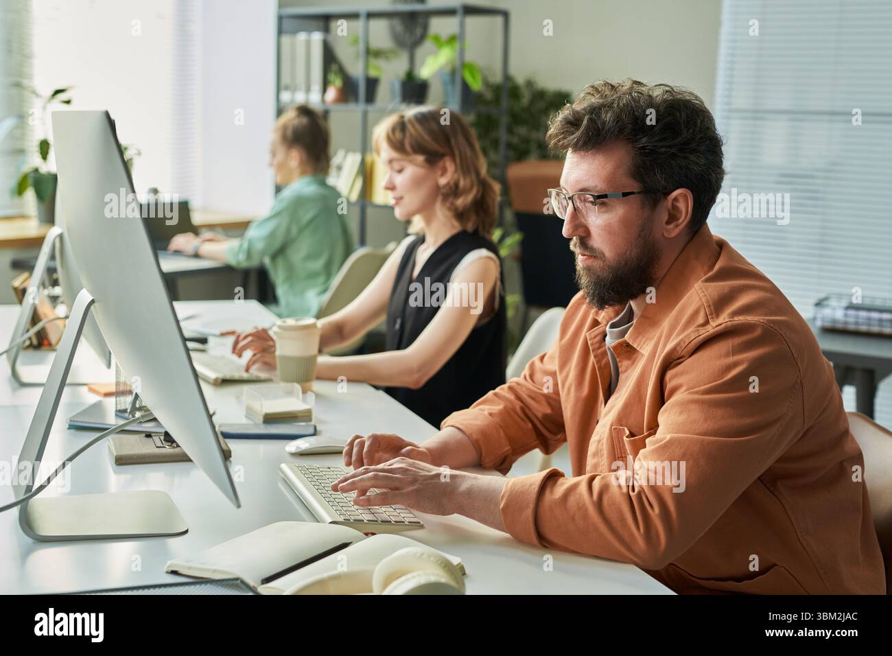 Caucasian Man Developing Neural Network with Colleagues in Office Stock Photo