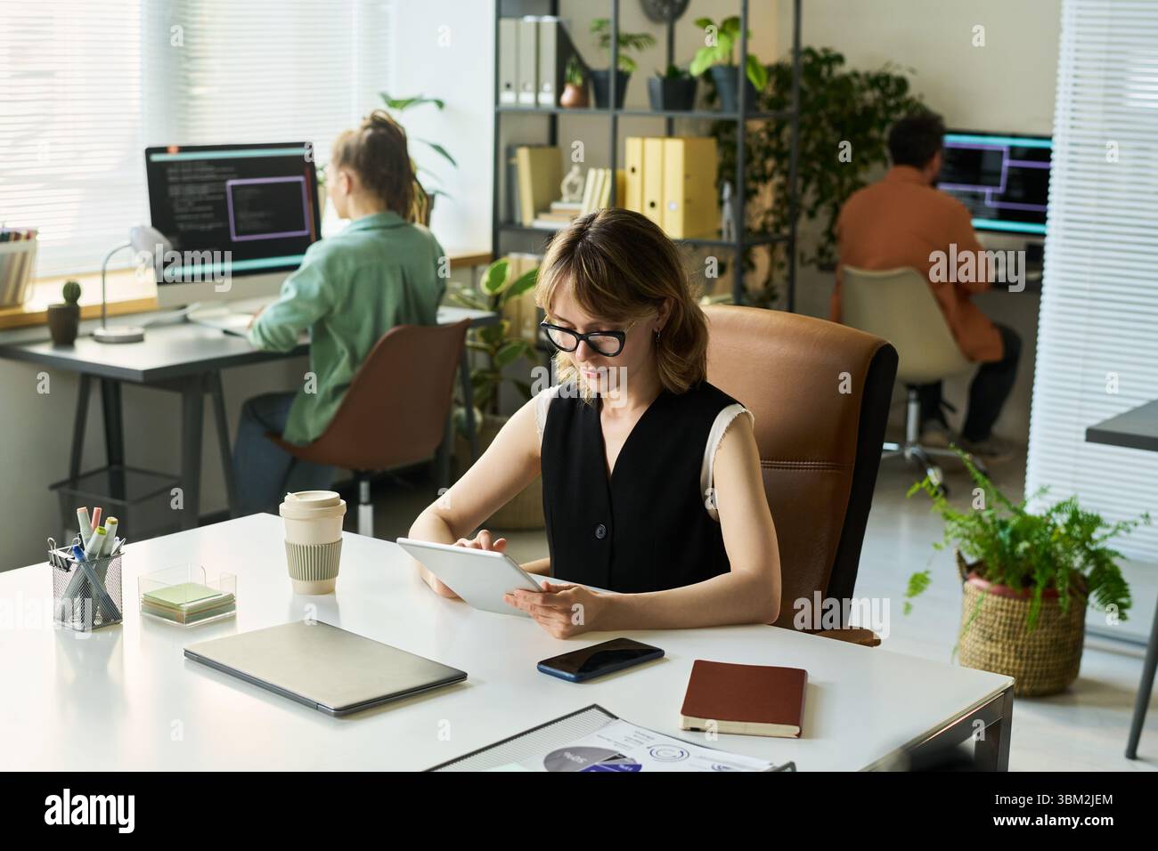 Young Caucasian Woman Developing Neural Network Algorithm on Digital Tablet Stock Photo