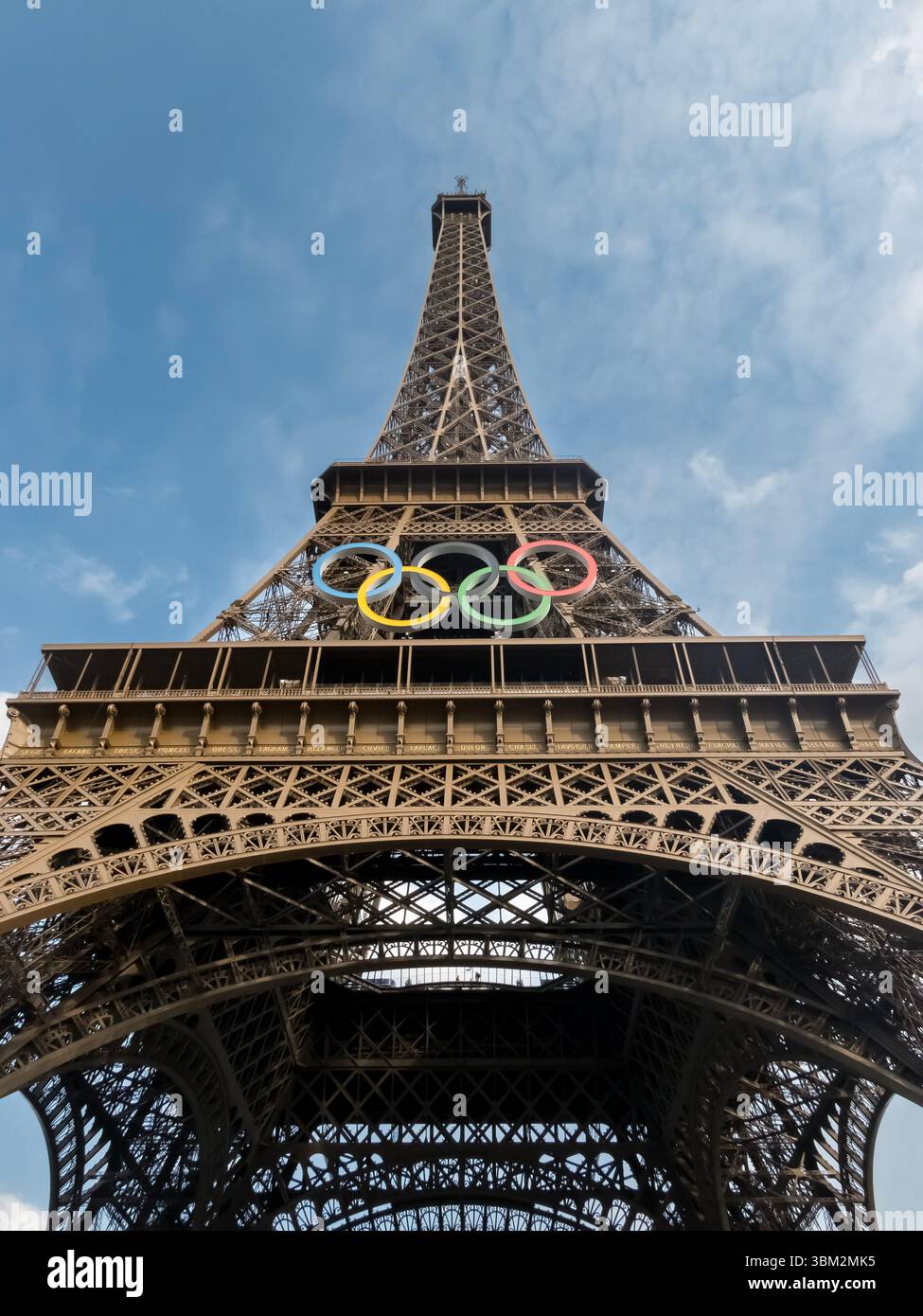 The Eiffel Tower in Paris, adorned with the Olympic rings, shines as a ...