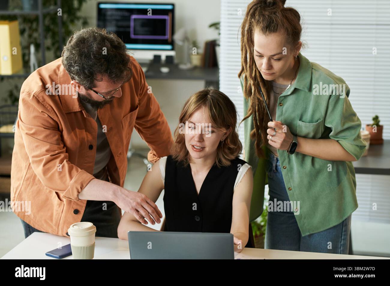 Multiethnic Young Adults Collaborating on Neural Network Development Project Stock Photo