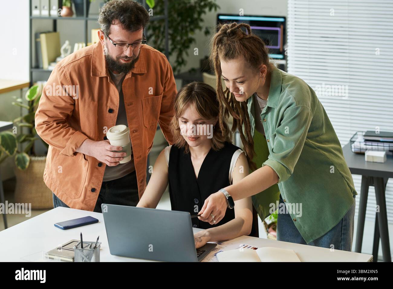 Woman Collaborating with Colleagues on Neural Network Development Stock Photo