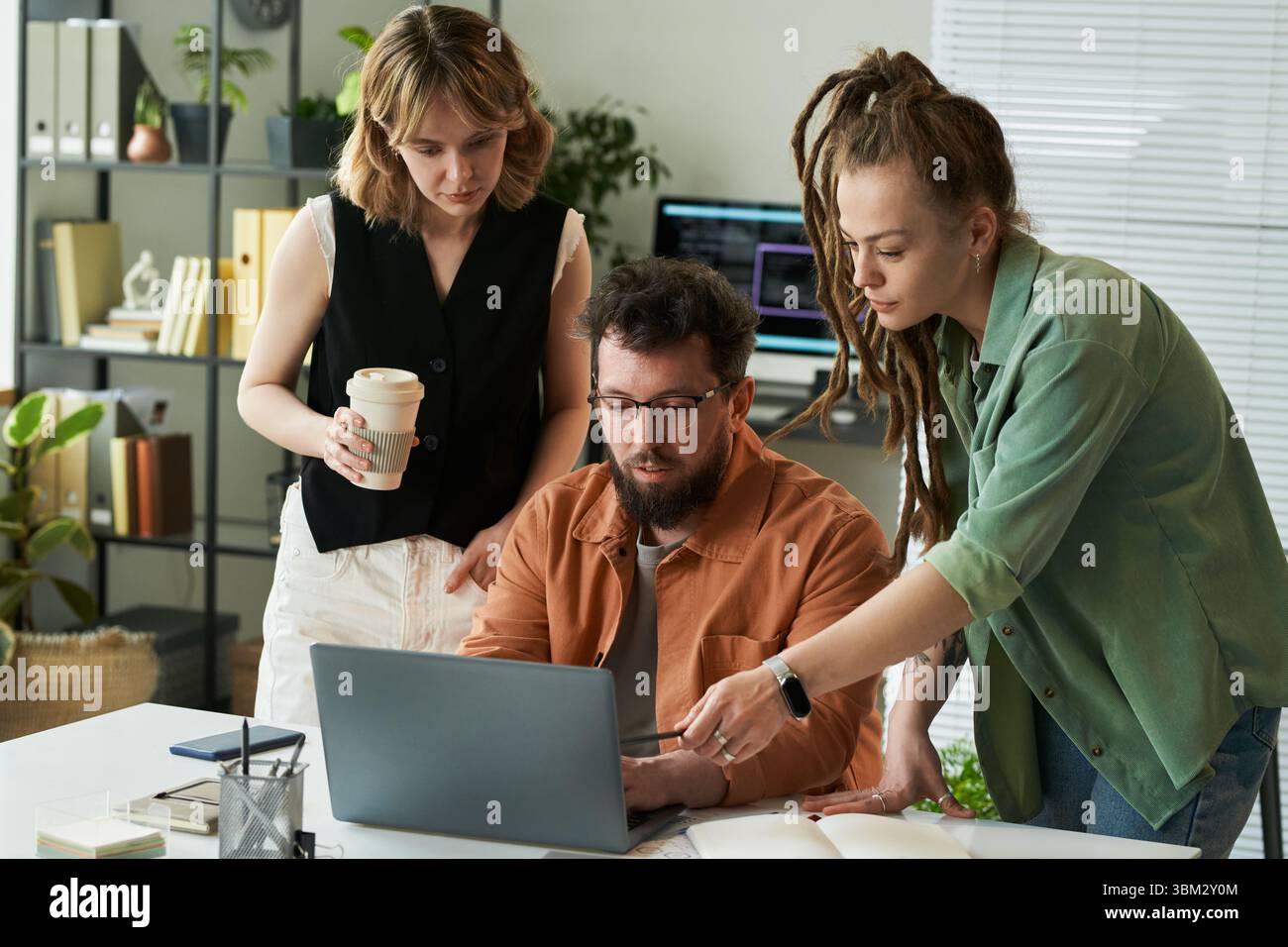 Young Adult Multiethnic Team Collaborating on Neural Network Development Project Stock Photo