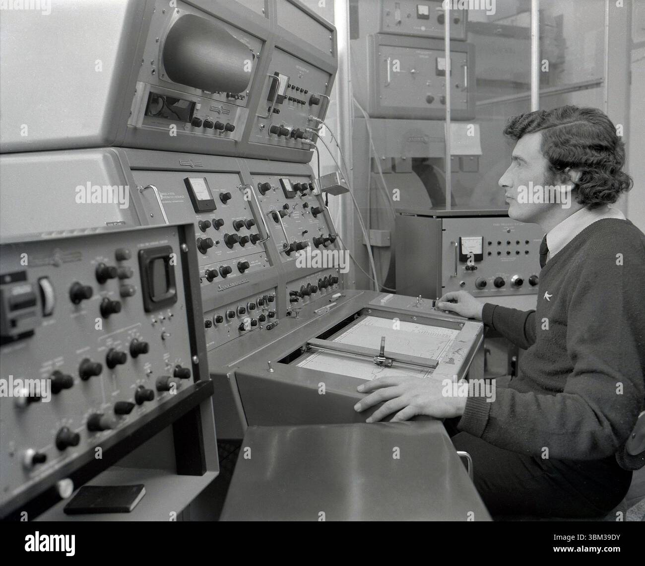 1970s, historical, a male post-graduate research scientist sitting at a ...