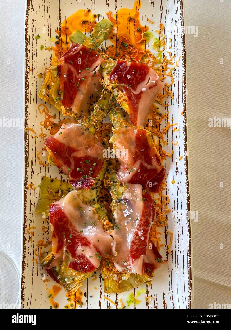 Artichokes with Iberian ham. Spain. - Smartphone Captured Stock Image