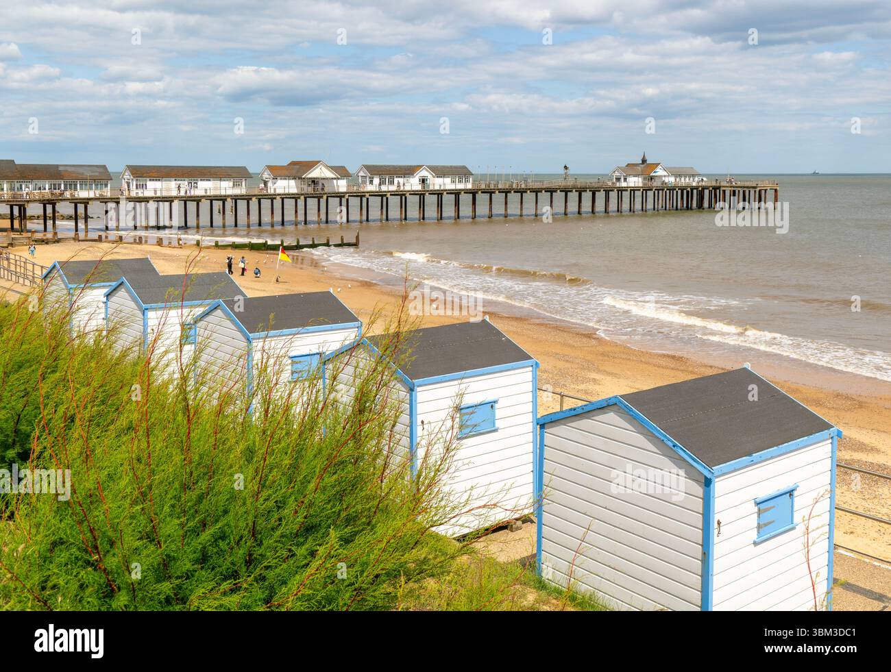 View over beach huts to sandy beach and pier, Southwold, Suffolk, England, UK Stock Photo