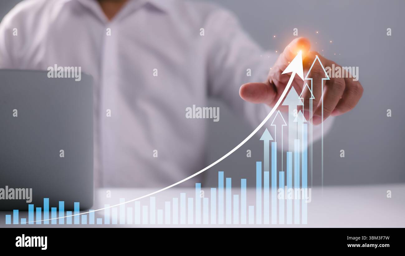 Businessman pointing at upward graph with glowing arrows, representing