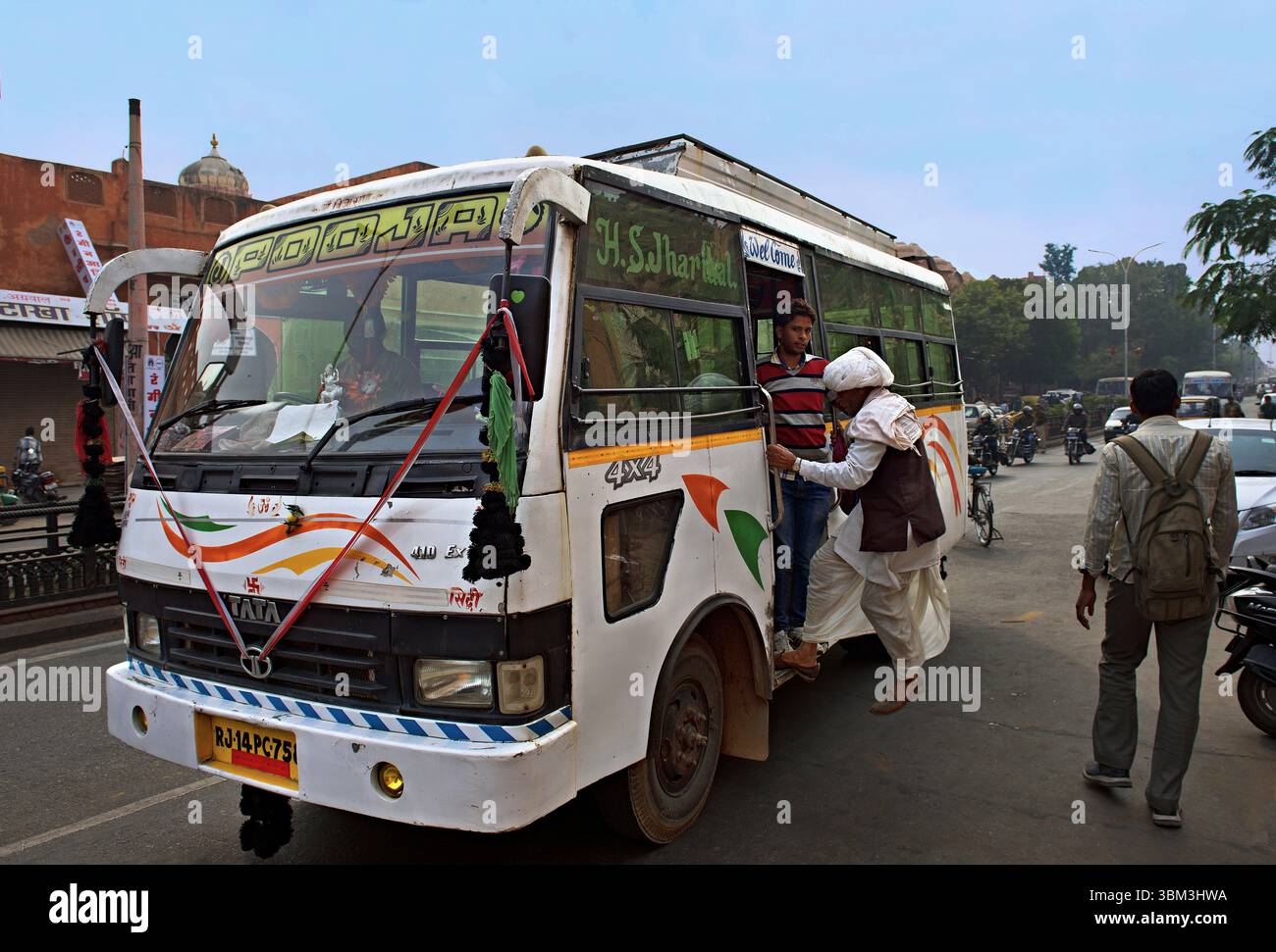 Man jumping on bus in Jaipur, India Stock Photo