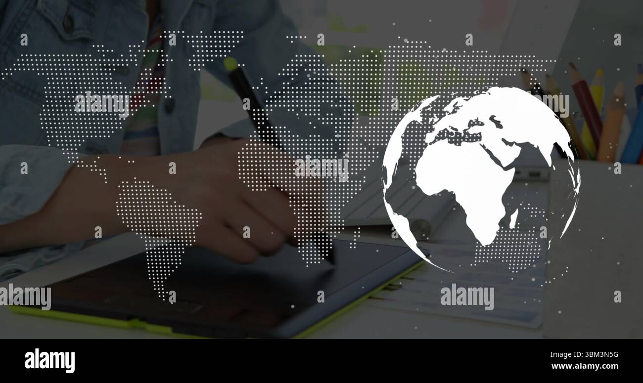 Holding stylus, artist drawing on tablet at desk, showing colored pencils and world map overlay Stock Photo