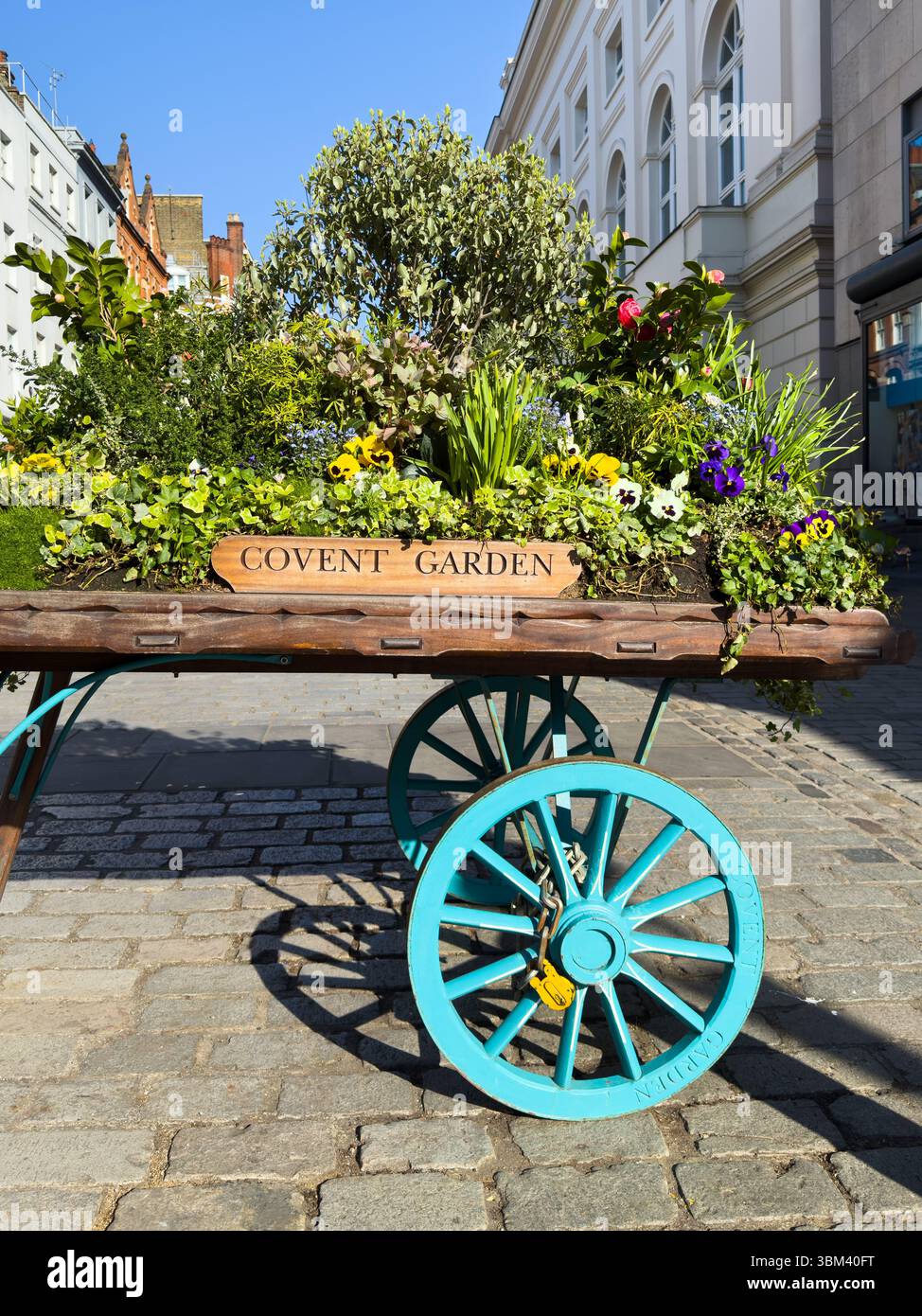 London, UK - April 2, 2025 Traditional barrow with Covent Garden sign in central London street Stock Photo