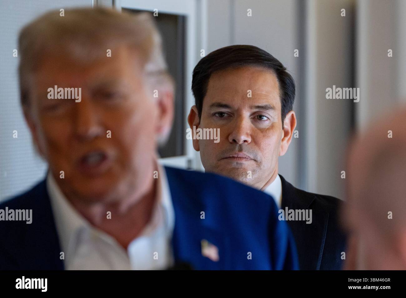 Secretary of State Marco Rubio stands behind as President Donald Trump ...