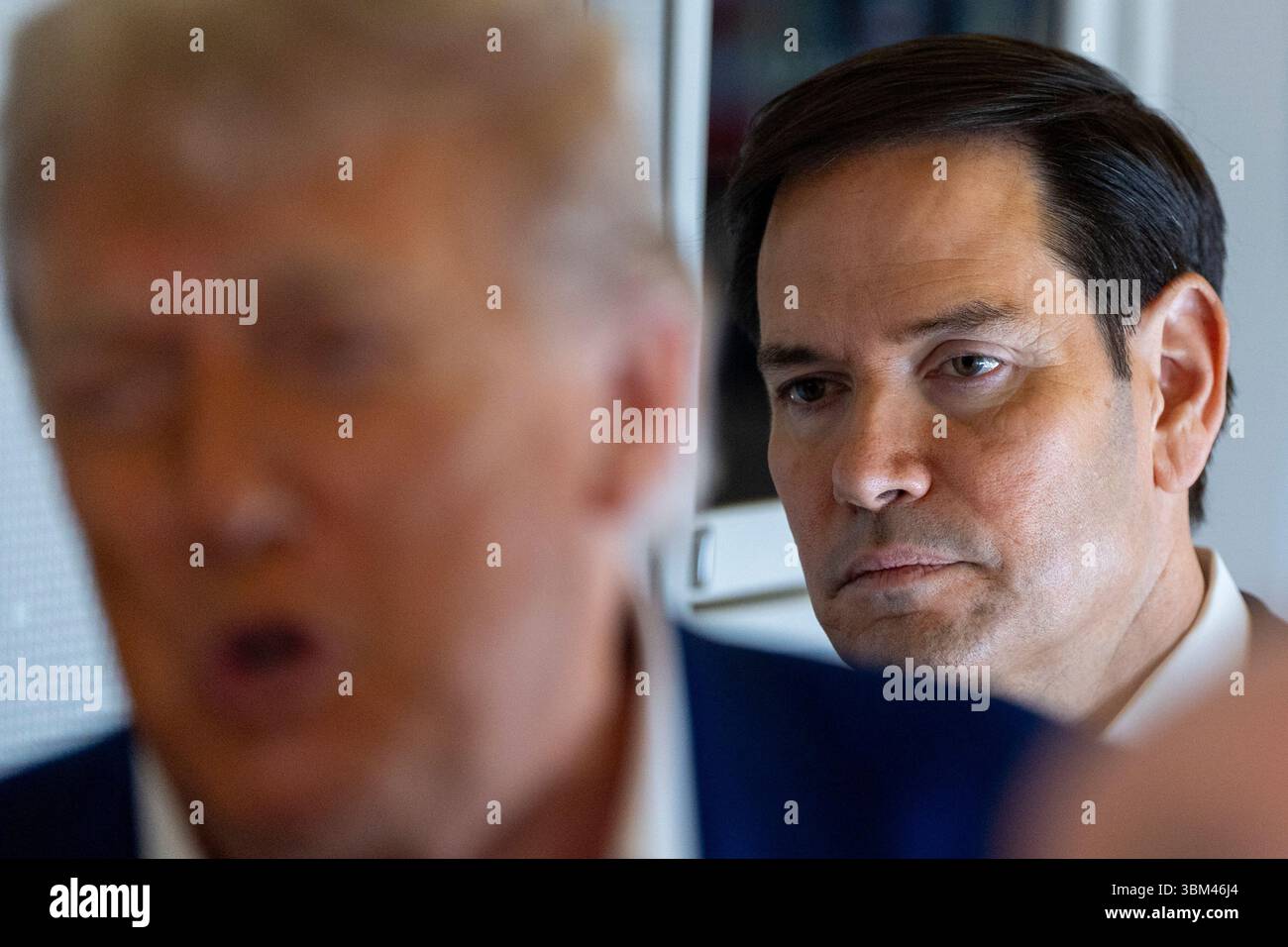 Secretary of State Marco Rubio stands behind as President Donald Trump ...