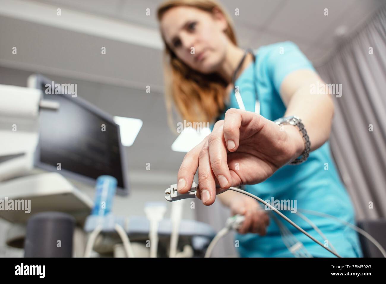 A cardiologist is doing a procedure to check the heart. Cardiologist ...