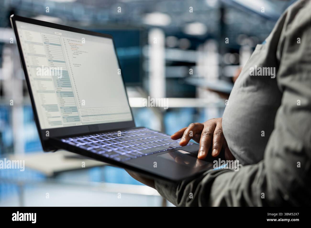 Close up of laptop used by data center software developer to upgrade system stability. Server hub IT professional coding, optimizing performance with device, configuring gear Stock Photo