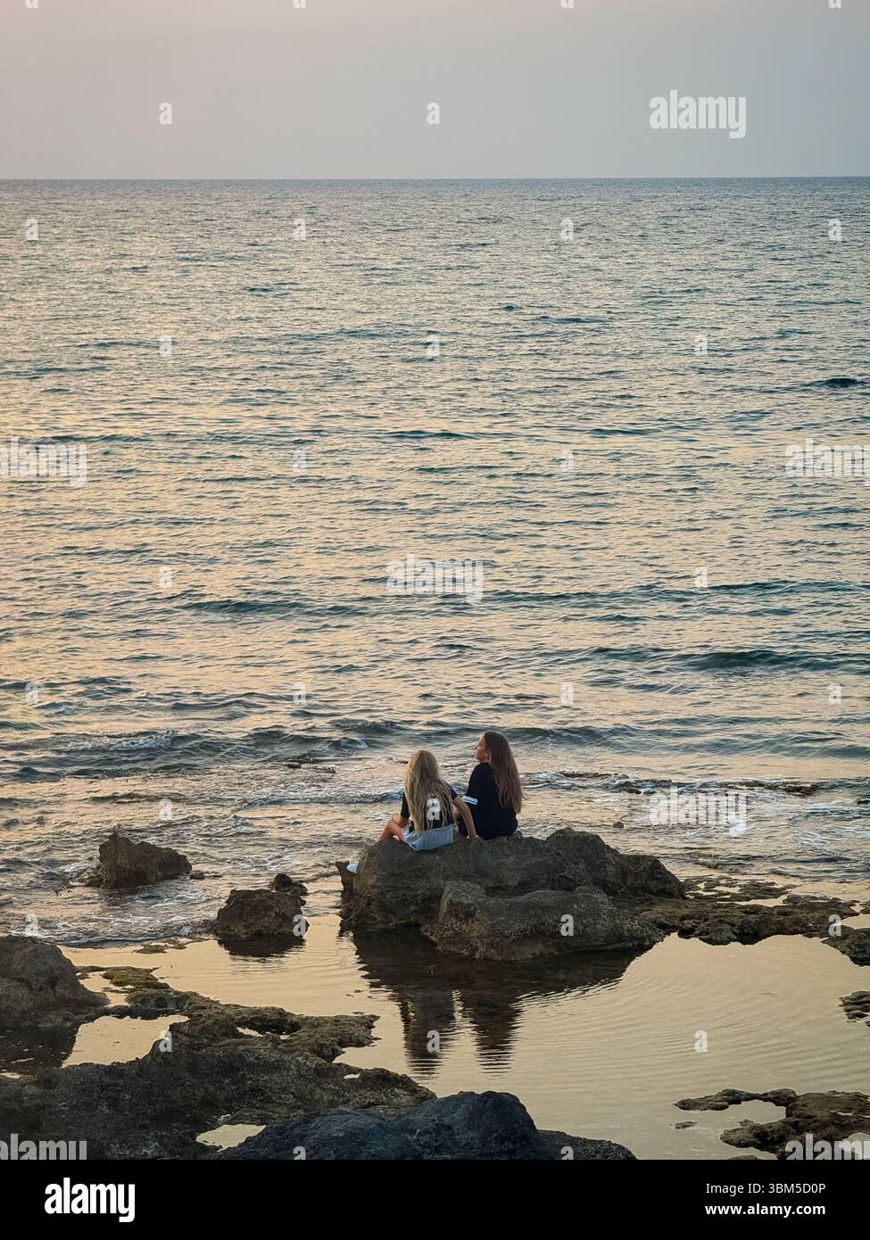 Two bestfriend having fun sitting in the seashore. best friend and ocean. - Smartphone Captured Stock Image