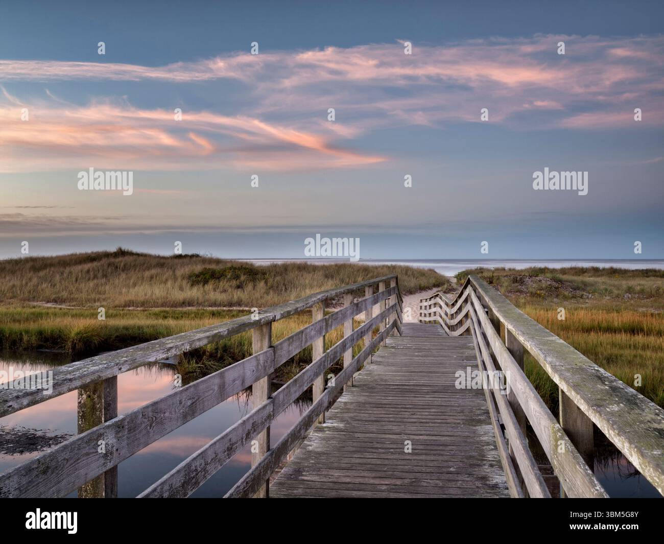 USA, Massachusetts, Cape Cod, Chatham. Dawn from rustic walkway at ...