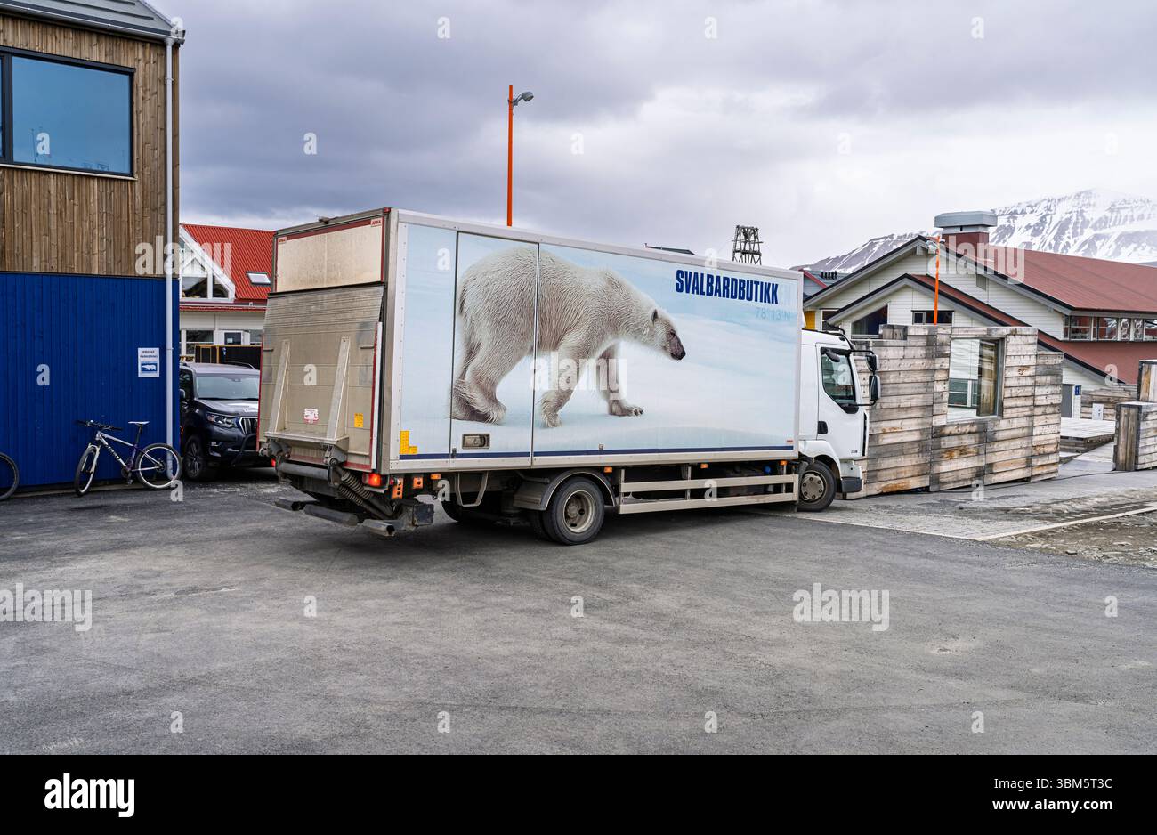 A local delivery lorry with picture of a polar bear on its side in a street scene in Longyearbyen, Svalbard, the world's northernmost settlement Stock Photo
