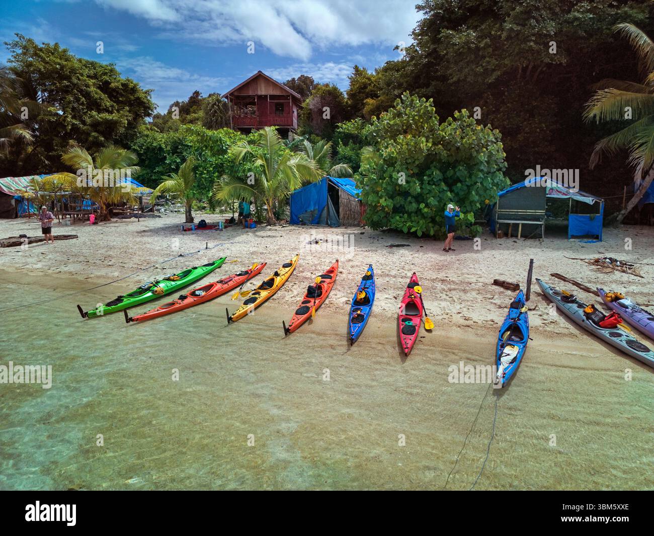 Kayaks, outer archipelago, Misool, Raja Ampat, Southwest Papua, Indonesia - aerial Stock Photo