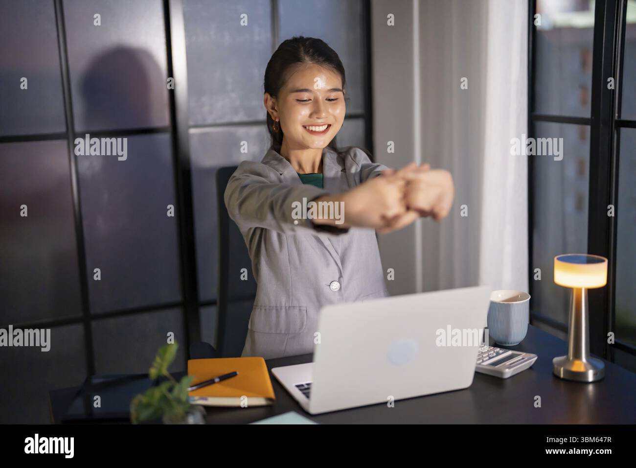 Alone Working Late at Night. Asian business woman at workplace in ...