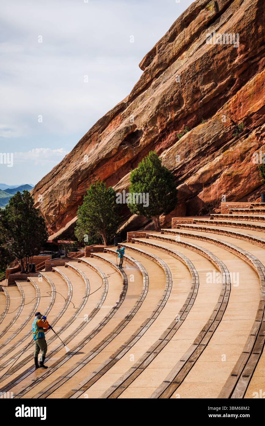 Workers hose down the seating at the famous Red Rocks amphitheater ...