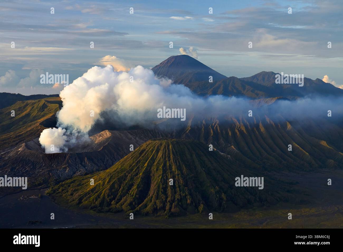 Smoke and steam coming from Mt Bromo (Gunung Bromo) with Mt Semeru smoking in distance, East Java, Indonesia Stock Photo