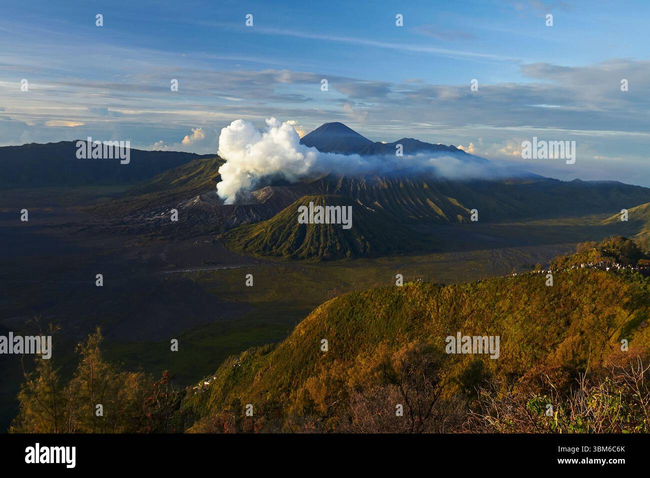 Smoke and steam coming from Mt Bromo (Gunung Bromo) with Mt Semeru in distance, East Java, Indonesia Stock Photo