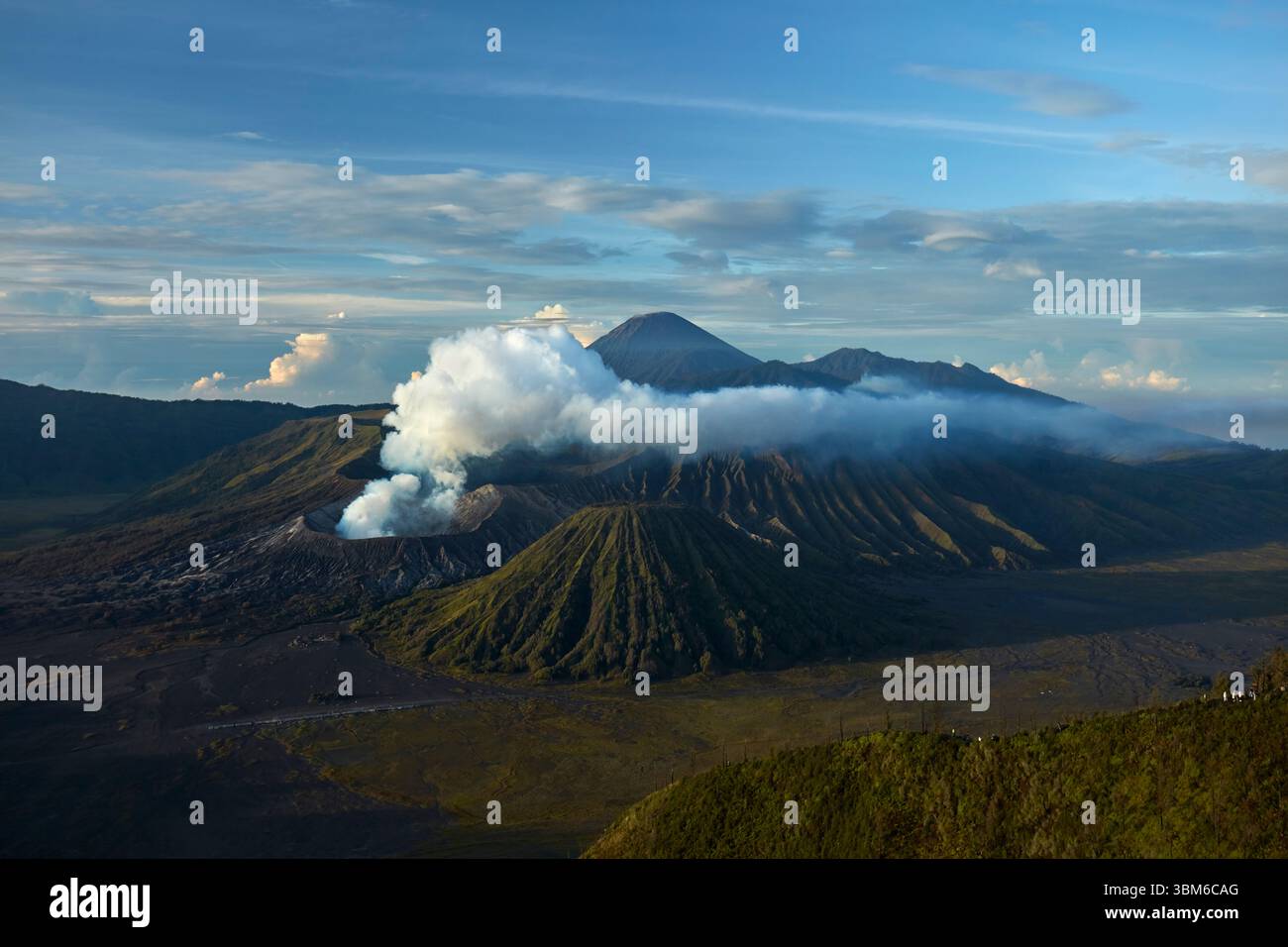 Smoke and steam coming from Mt Bromo (Gunung Bromo) with Mt Semeru in distance, East Java, Indonesia Stock Photo