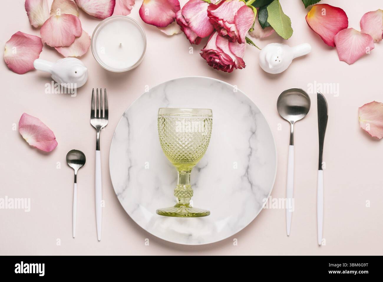 Romantic table setting in pink colors. Tableware and decorations for serving a festive table Stock Photo