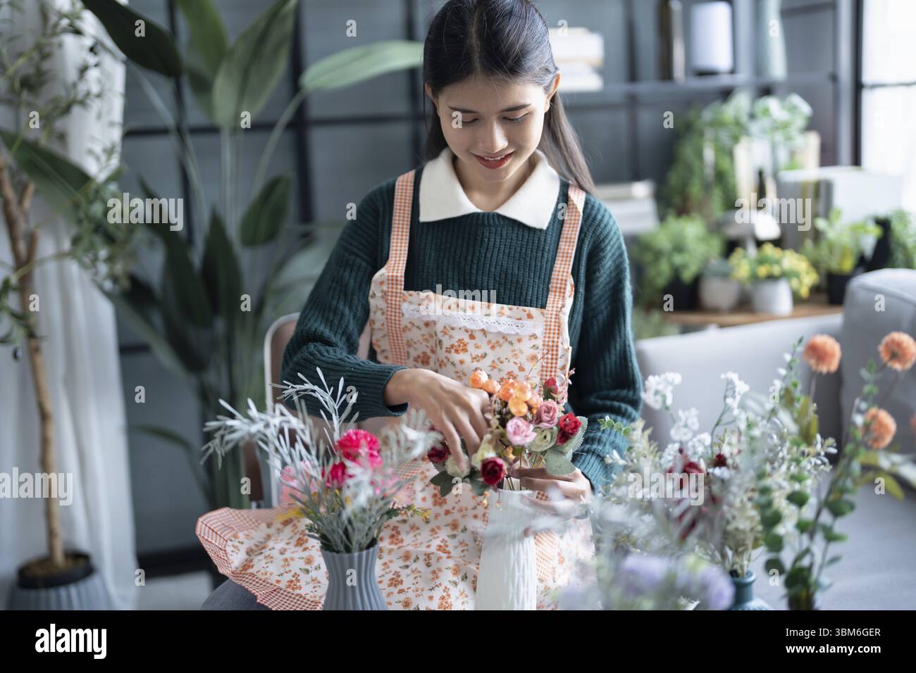 Happy asian female florist Startup small business successful SME in flowers shop Stock Photo