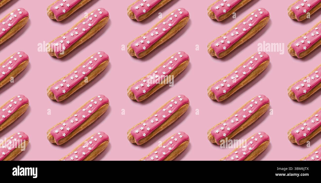 Seamless food creative texture or background. Eclairs pattern with pink icing and stars sprinkled on pink background Stock Photo