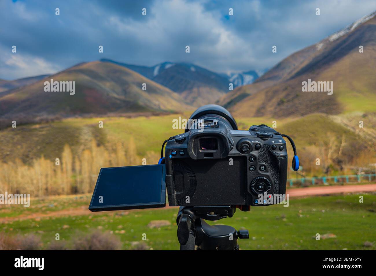 Camera on tripod capturing serene mountain landscape Stock Photo