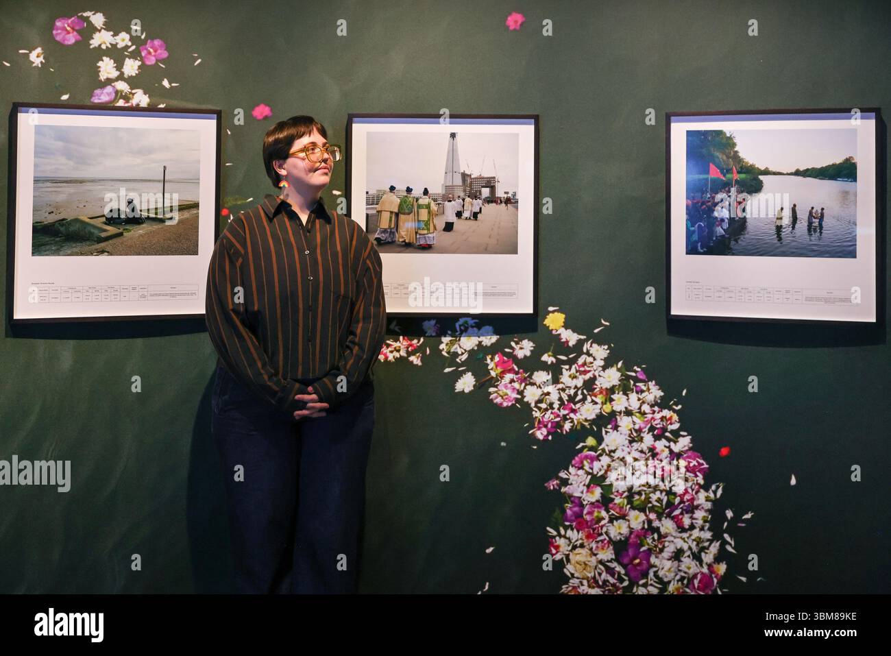 London, UK. 25th June, 2025. Museum staff with (l-t-r-) 'Blessing of the River', Maghrib/Evening Prayer', 'Scatttering of Ashes' and 'Mass Baptism', 2013-16, all by Chloe Dewe Mathews. Wellcome Collection launches its major new exhibition 'Thirst: In Search of Freshwater' during London Climate Action Week, featuring ancient artefacts and contemporary artworks that explore the impact of freshwater on health. Running 26 June 2025 - 1 Feb 2026. Credit: Imageplotter/Alamy Live News Stock Photo