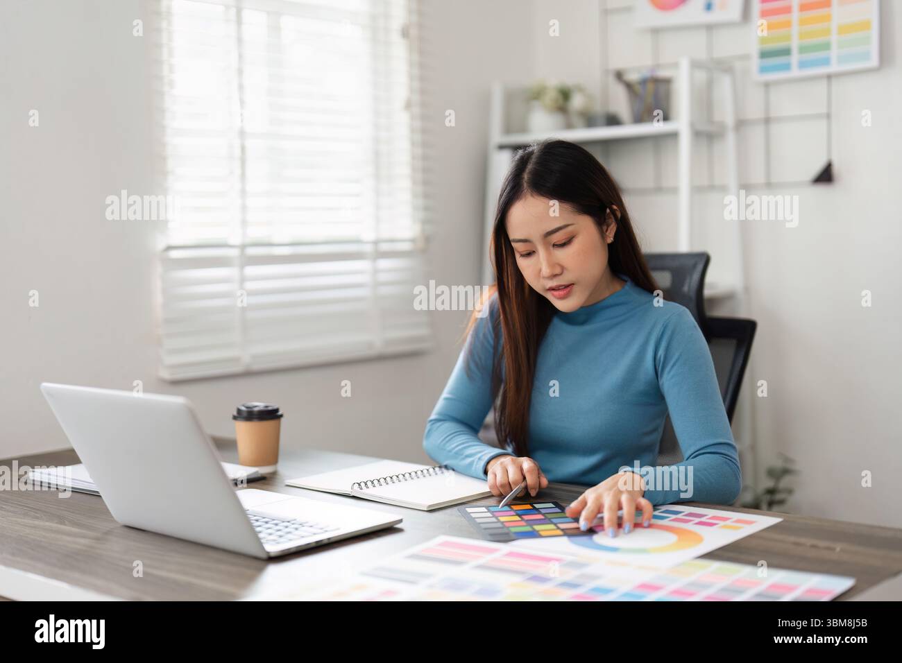 Color Selection and Creative Design. A focused designer exploring color ...