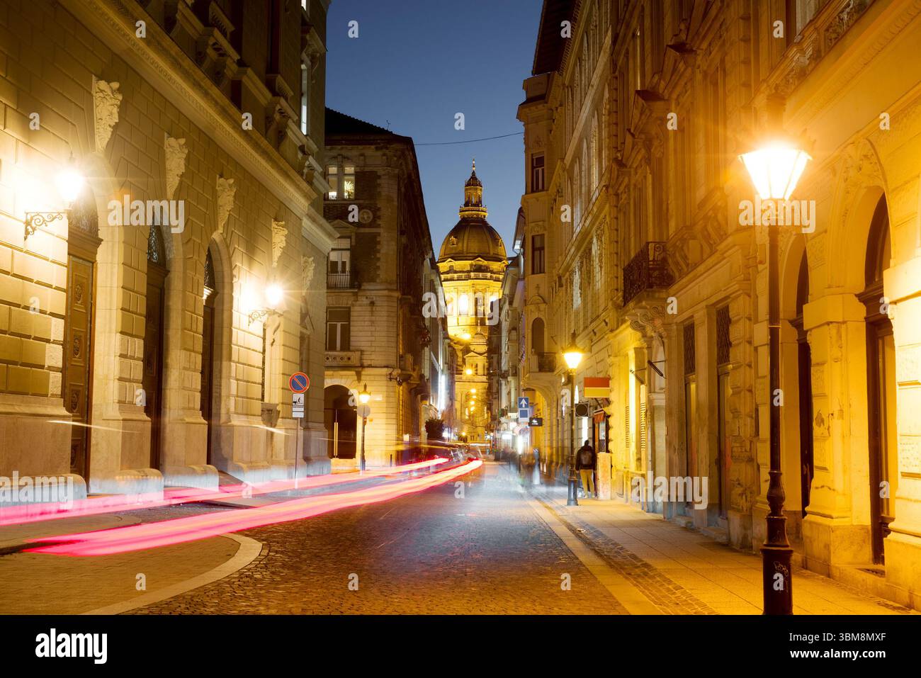 Night view of Lázár street featuring St. Stephen's Basilica Stock Photo