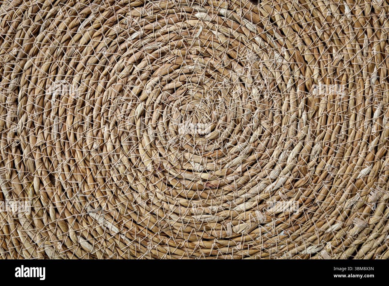Intricate spiral straw natural texture background Stock Photo