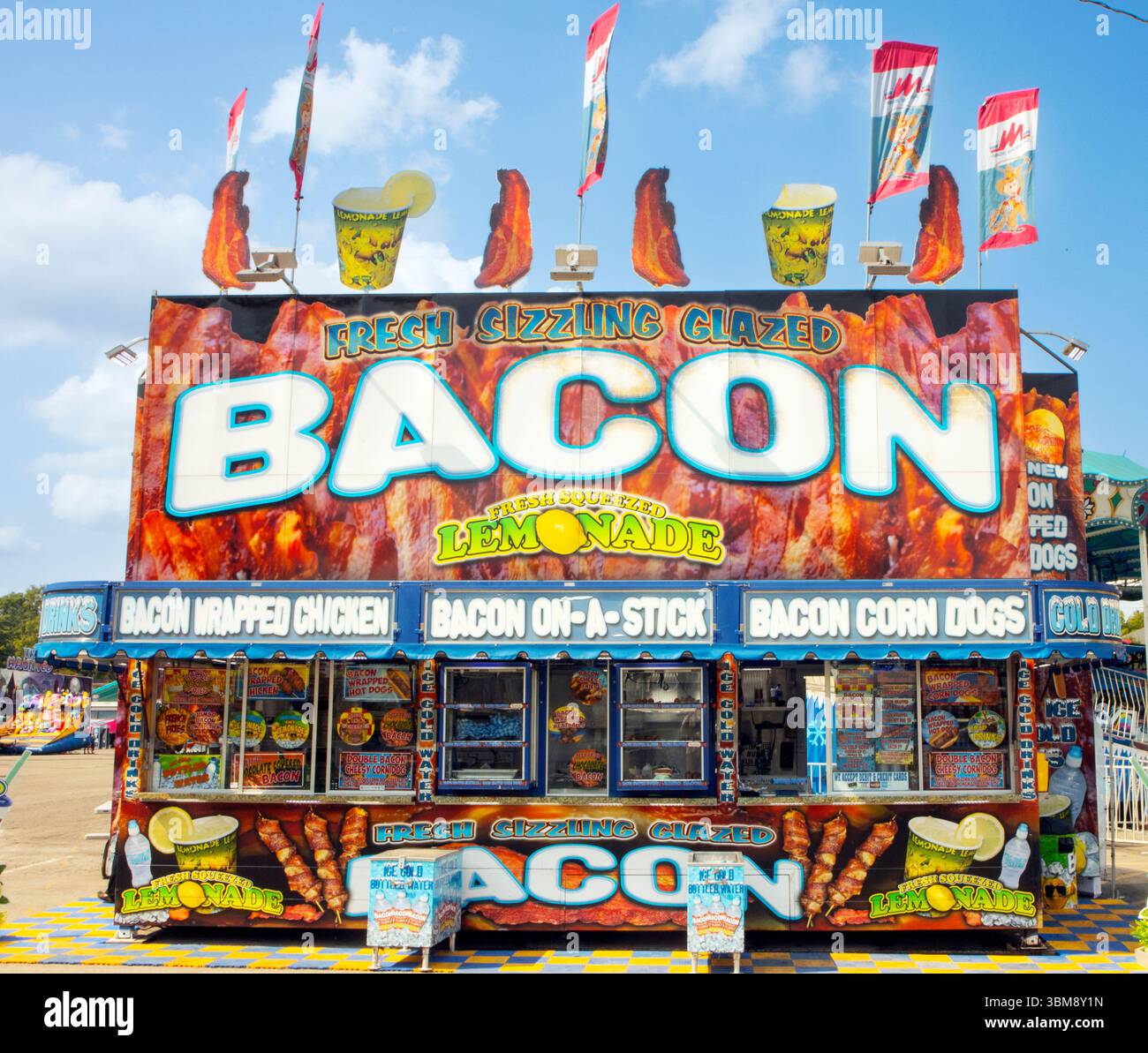 Colorful food stall in Knoxville, Tennessee, at an outdoor festival advertises sizzling bacon dishes and fresh lemonade to visitors. Stock Photo