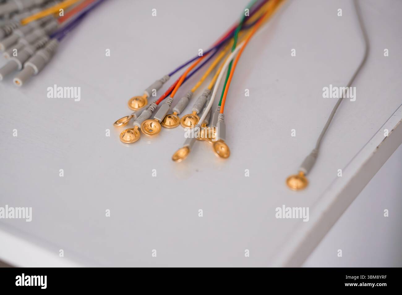 Close-up of Colorful EEG Electrode Wires with Gold Tips on White ...