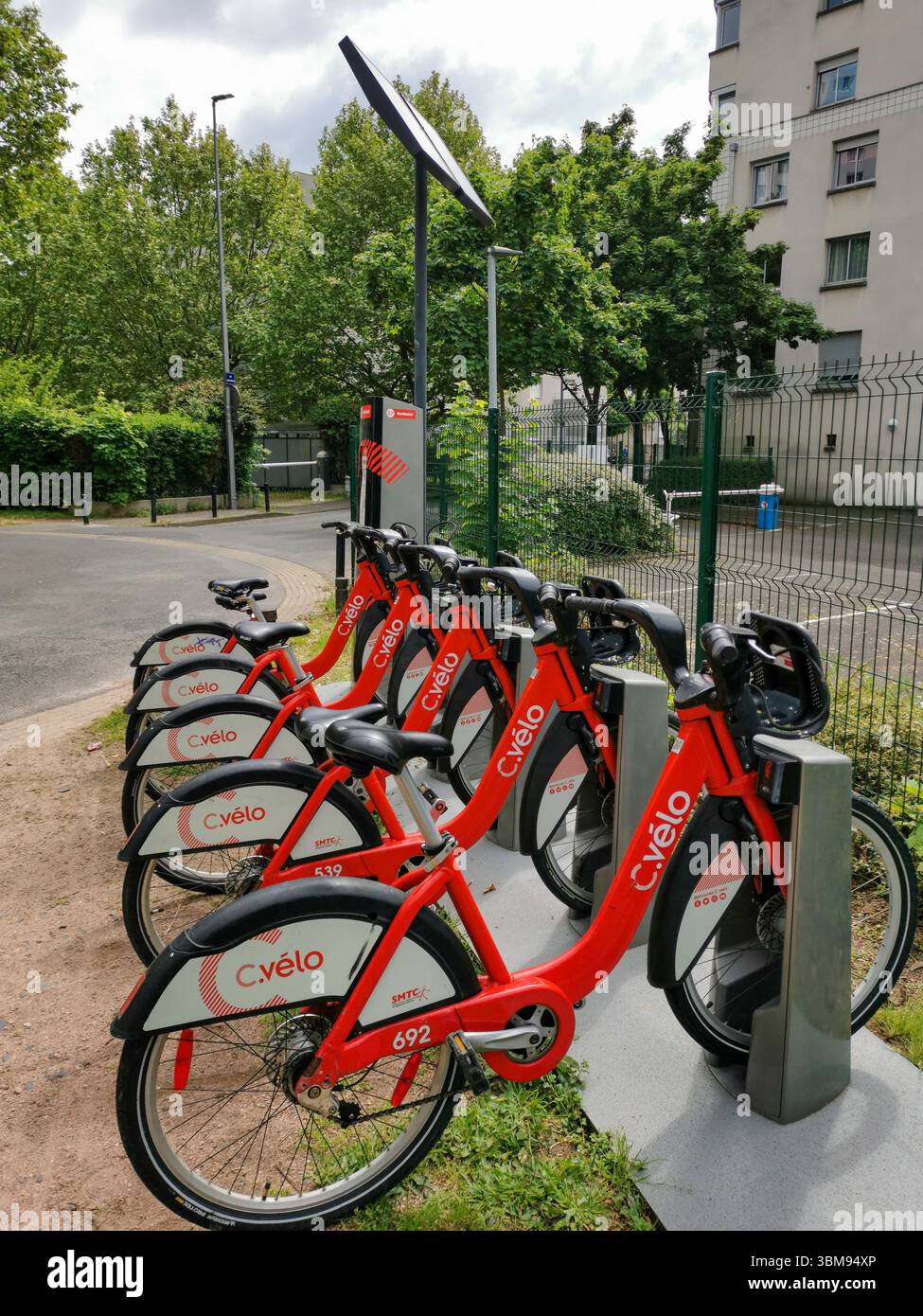 C velo bikes are lined up at a bike-sharing station in Clermont Ferrand, providing an eco-friendly transport option. Puy de Dome, Auvergne , France - Smartphone Captured Stock Image