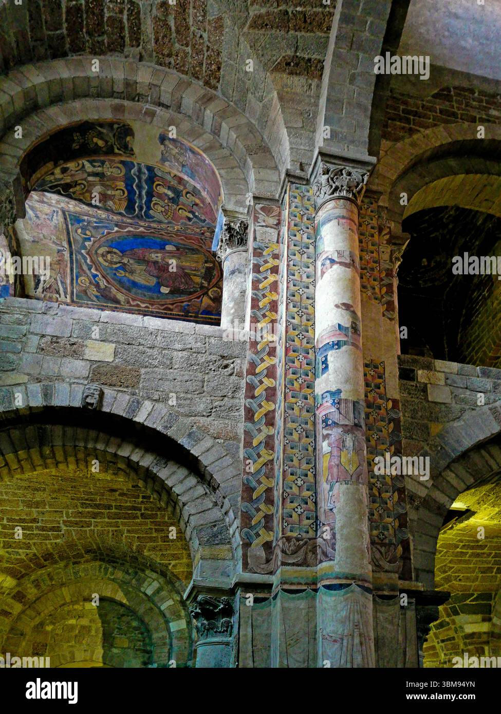 Frescoes adorn the pillars of Basilica Saint Julien in Brioude, revealing  biblical scenes and saints. Haute Loire. Auvergne Rhone Alpes. France - Smartphone Captured Stock Image