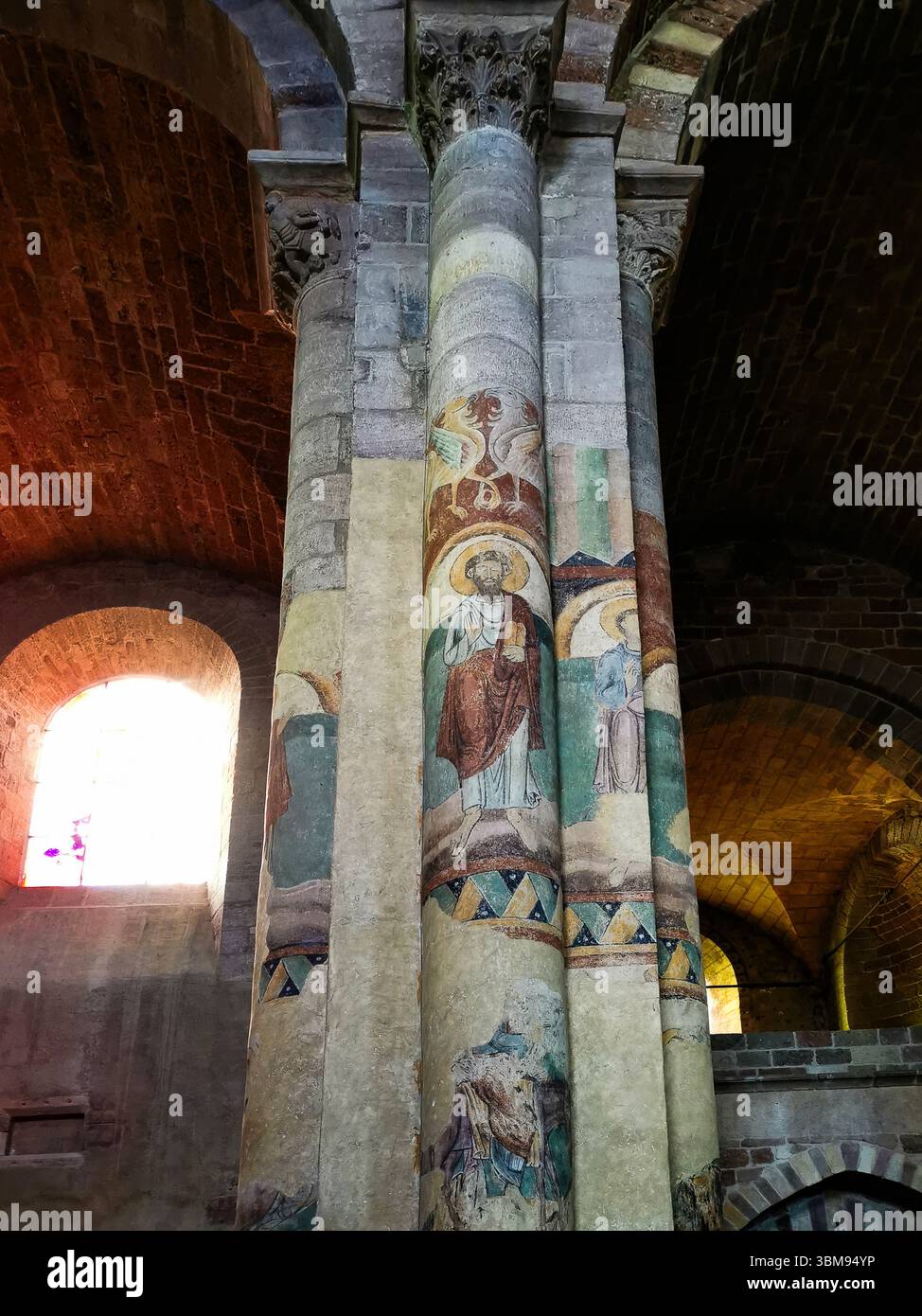 Frescoes adorn the pillars of Basilica Saint Julien in Brioude, revealing  biblical scenes and saints. Haute Loire. Auvergne Rhone Alpes. France - Smartphone Captured Stock Image