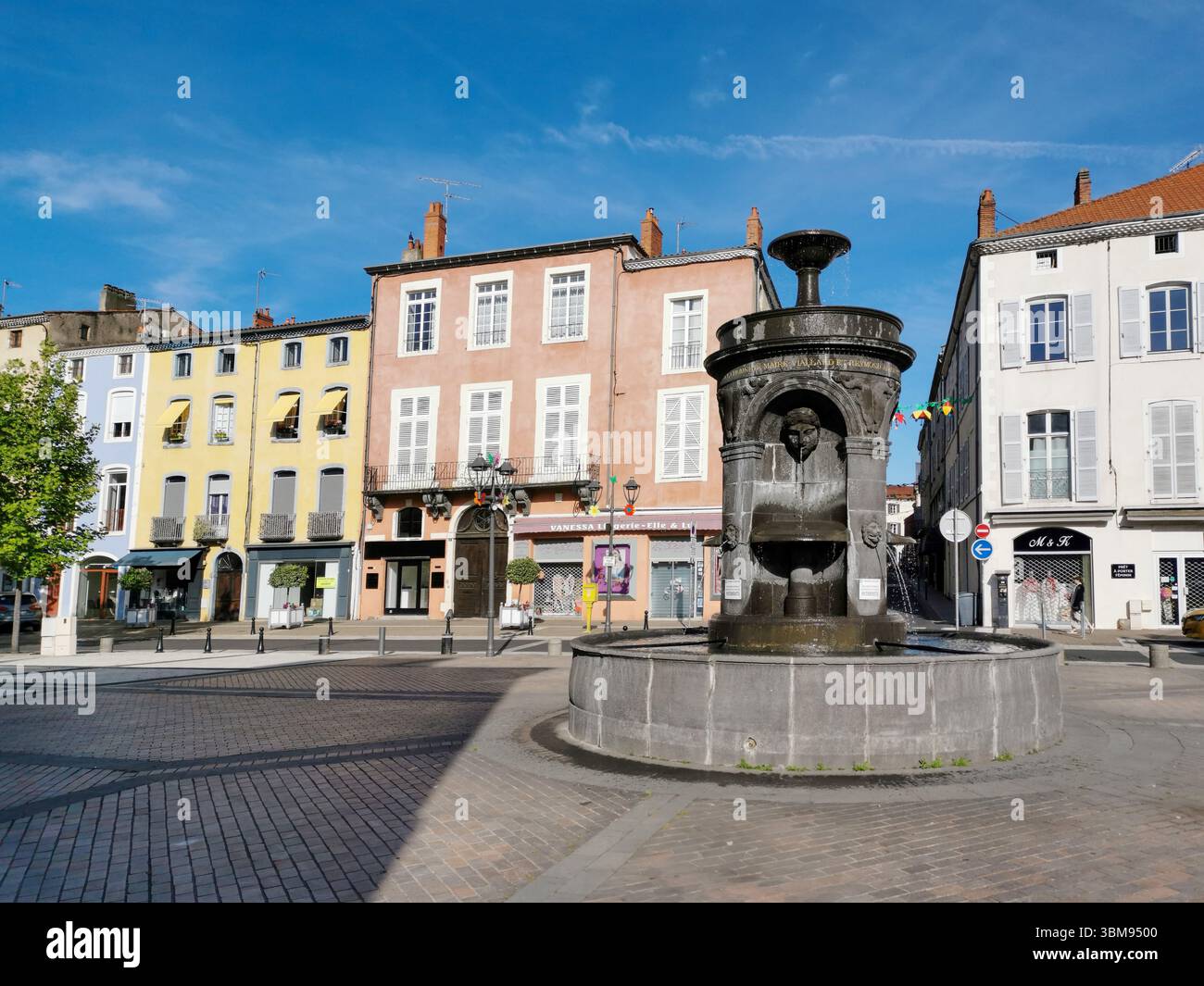 Fountain Square in Issoire ( place de la République) features an ornate fountain surrounded by charming buildings. Puy de Dome. Auvergne. France - Smartphone Captured Stock Image
