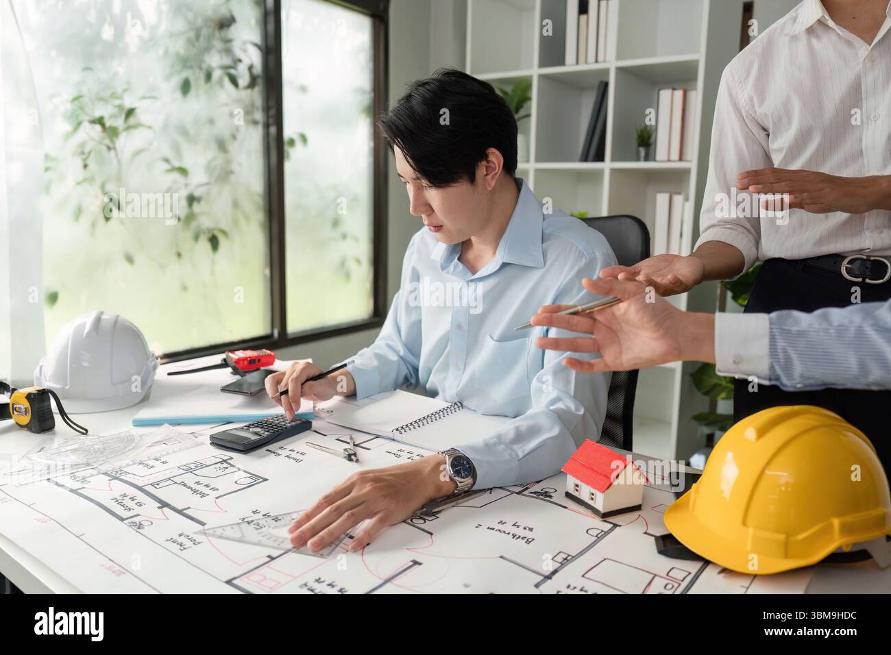 Design Development and Collaboration. An architect analyzing project ...