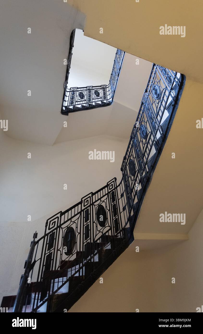 Low angle view of an elegant staircase with decorative black metal ...