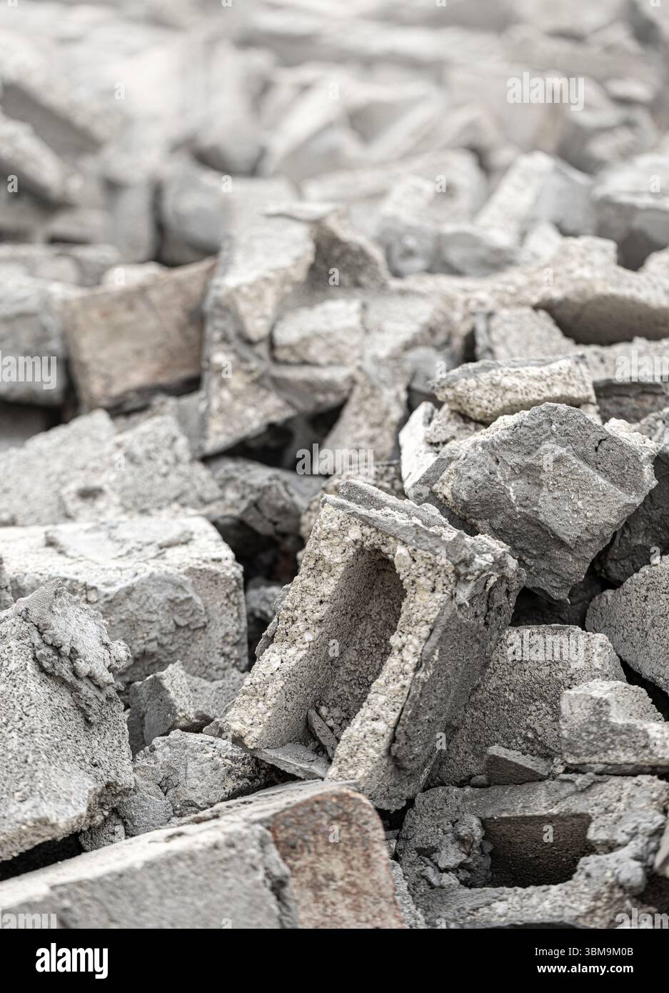 Gray concrete and brick rubble debris creating a large pile after ...
