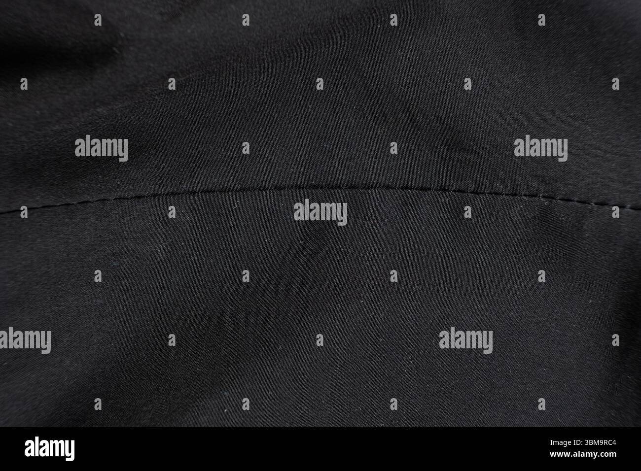 Old worn-out polyester and elastane fabric, pilling and frayed threads. Stock Photo